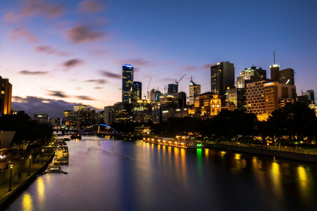 yarra river between buildings during golden hour