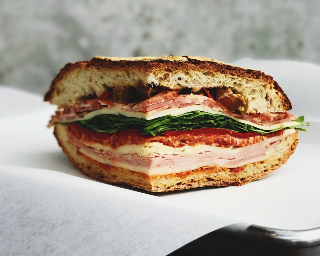 ham deli sandwich on white surface