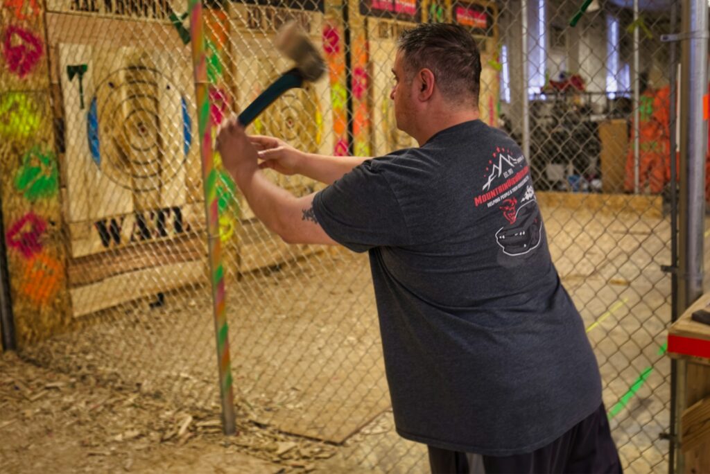 a man axe throwing indoors