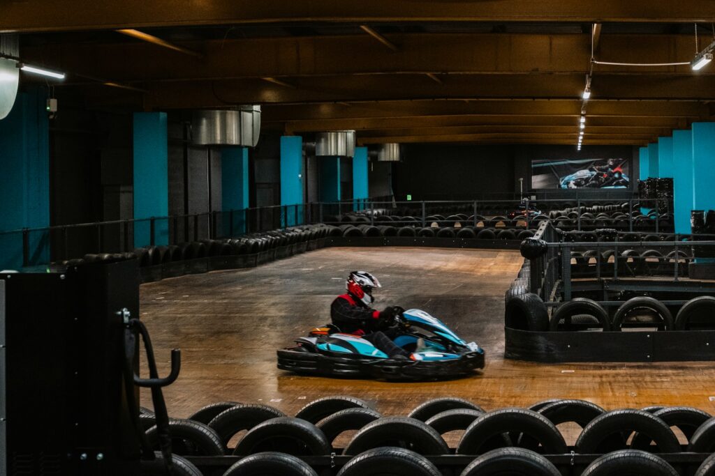 a person riding a go kart in a building