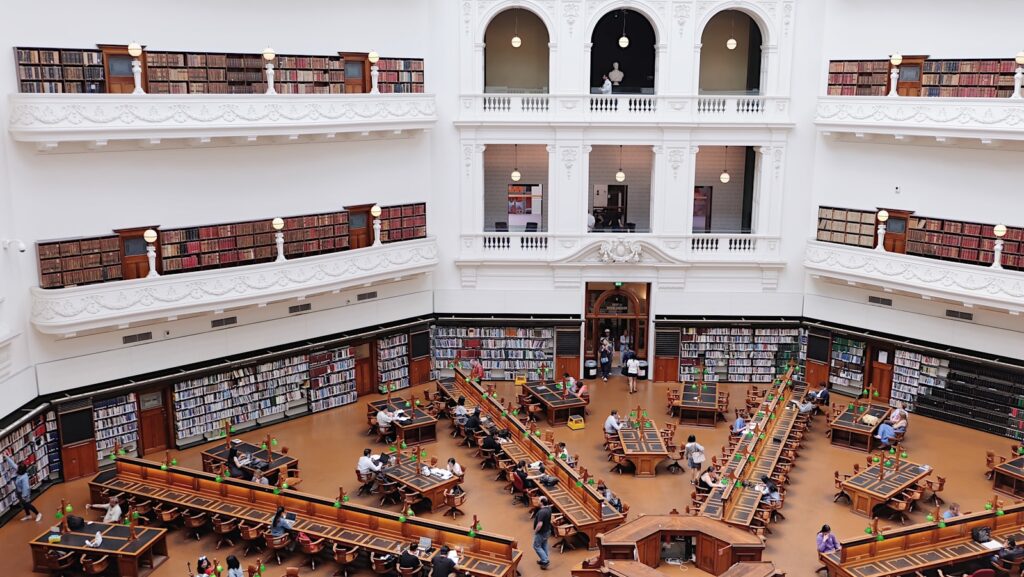 aerial photography of people reading books inside victoria state library