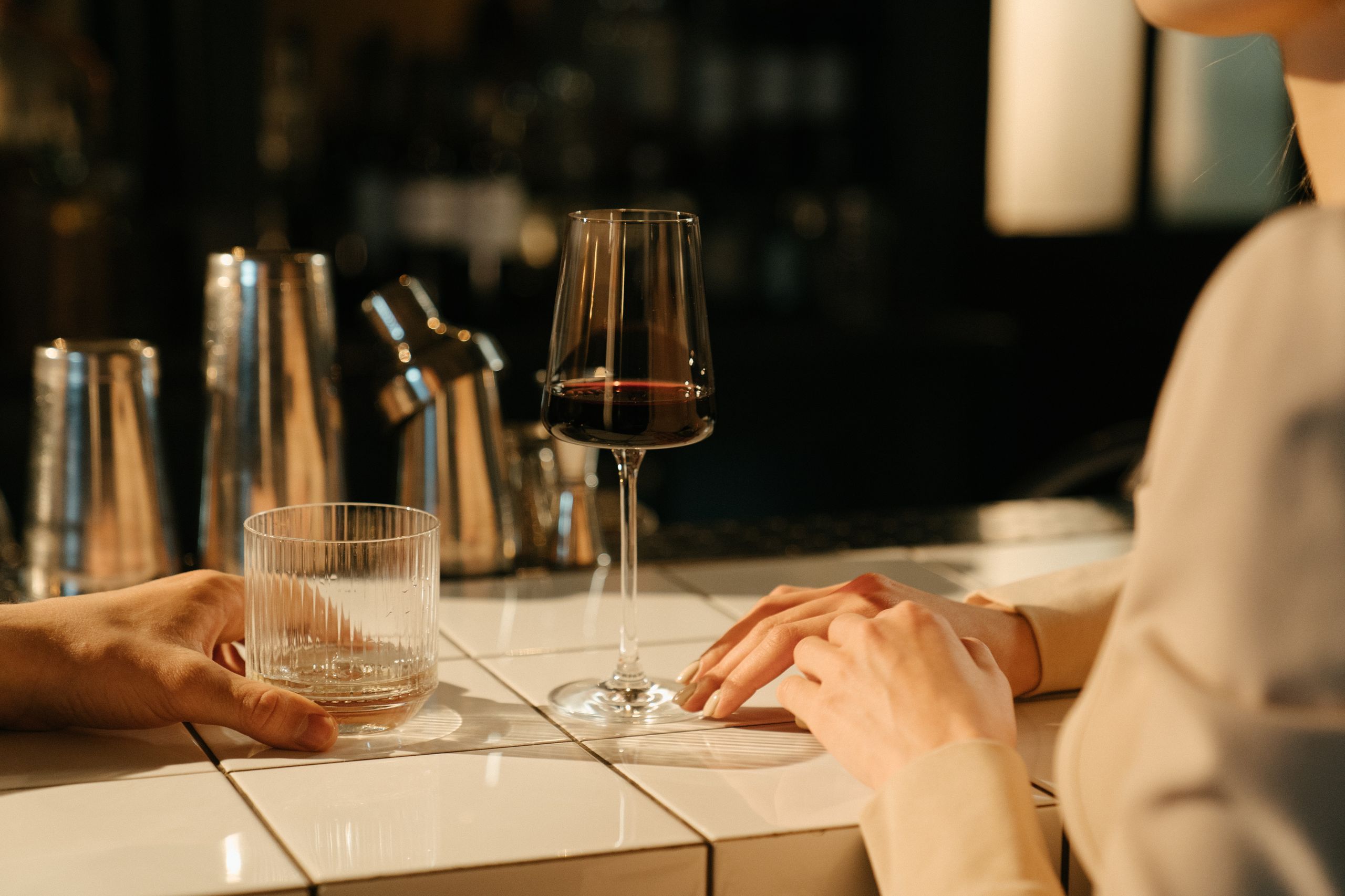 An intimate bar setting capturing a quiet moment with drinks and conversation.